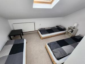 a room with two beds and a table in it at Casa Campionilor in Hodoşa