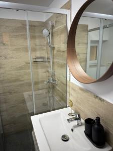 a bathroom with a sink and a shower with a mirror at Casa TeoMar in Brad +38 photos