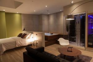 a bedroom with a bed and a living room at My Spa in Reims