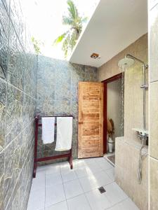 a bathroom with a shower and a tub and a sink at Oemau Bungalow in Nembrala