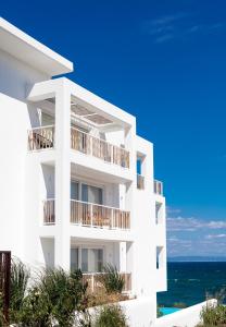 a white building with the ocean in the background at Sea Sense Boutique Villa & Relax Zone in Sozopol