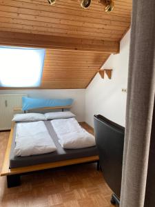 a bedroom with a bed with a wooden ceiling at Dachgeschosswohnung im zweiten Obergeschoss in Bruck in der Oberpfalz