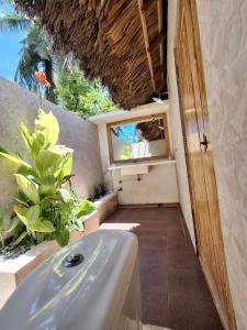 a bathroom with a sink and a window at Oemau Bungalow in Nembrala
