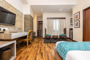 a hotel room with a bed and a desk at Hotel Arts Kathmandu in Kathmandu