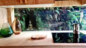 a counter with two vases and a fish tank at Nordic Noir Cabin in Queenstown +11 photos
