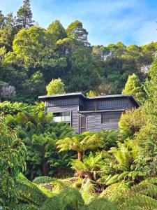 a house in the middle of a forest at Nordic Noir Cabin in Queenstown