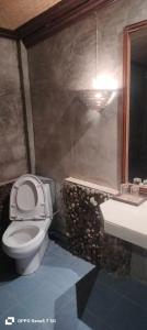 a bathroom with a toilet and a sink at เวียงล้านนา รีสอร์ท in Ban Muang Pha