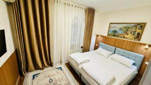 a bedroom with a bed and a window at Samarkand Travel in Samarkand