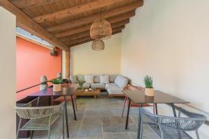 a living room with two tables and a couch at Villa Il Platano in Como
