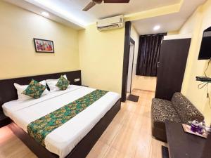 a hotel room with a bed and a couch at Hotel Wardhman in Jabalpur +45 photos