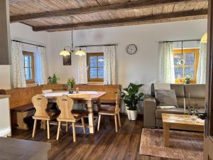 a dining room and living room with a table and chairs at Huber's Ferienhaus 28 in Leutschach