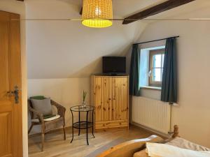 a room with a bed and a table and a tv at Huber's Ferienhaus 28 in Leutschach