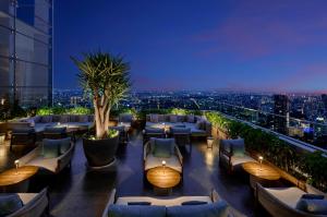 a restaurant with a view of a city at night at Pan Pacific Jakarta in Jakarta