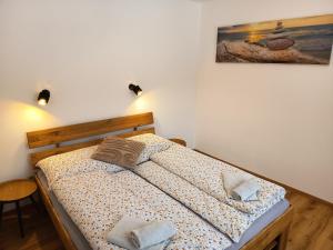 a bedroom with a bed with two pillows on it at Apartmán U nás in Malá Morávka