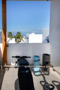 a row of barbells on top of a balcony at Outstanding Apartment in an Unique Aegean Inspired Settlement in Agia Triada