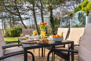 a table with food and drinks on a patio at Villa Beach & Golf in Julianadorp