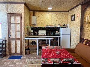 a kitchen with a refrigerator and a table in a room at Дом в Севан House in Sevan in Sevan
