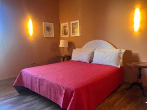 a bedroom with a large bed with a red blanket at Urban Po Mansarda in Santa Maria Maddalena