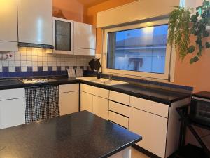 a kitchen with a sink and a window at Urban Po Mansarda in Santa Maria Maddalena