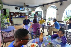 a group of people sitting at tables in a restaurant at Hotel Santo Tomas / Historical Property in San José