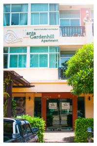 a building with a car rental appointment sign on it at Lanta Garden Hill Resort and Apartment in Ko Lanta