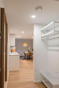 a kitchen and dining room with a staircase in a house at Komandandi Smart Stay City Center Apartments in Kuressaare