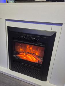 a fireplace with a fire inside of it at AFI Discret Jacuzzi in Bucharest