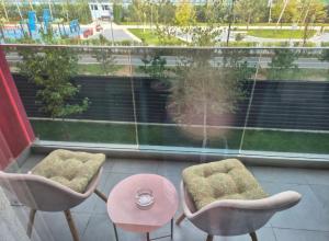 a view of a balcony with two chairs and a table at AFI Discret Jacuzzi in Bucharest
