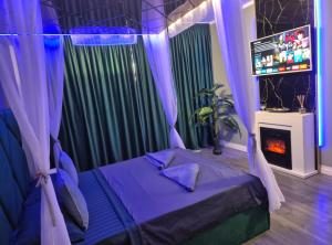 a bedroom with a bed with purple curtains and a fireplace at AFI Discret Jacuzzi in Bucharest +34 photos