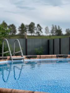 a large swimming pool with a fence at Opushka in Vorobʼyëvka