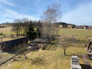 an aerial view of a farm with trees and a field at Dachgeschosswohnung im zweiten Obergeschoss in Bruck in der Oberpfalz