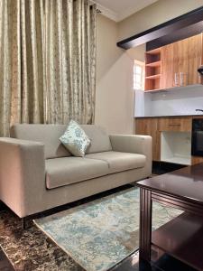 a living room with a couch and a table at Annavilla7 Lilongwe hotel in Lilongwe