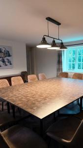 a dining room with a large wooden table and chairs at Superb Spacious Farm House in Henley on Thames +14 photos
