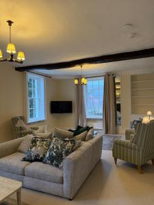 a living room with a couch and a tv at Superb Spacious Farm House in Henley on Thames