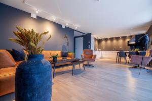 a living room with a couch and a table and chairs at Seaside Apartment in Lofoten - Sea Views in Ballstad
