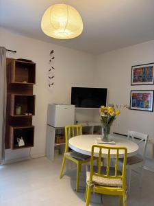 a dining room with a table and chairs and a television at LEGRAND Town Center in Makarska +15 photos