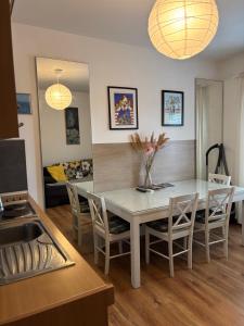 a kitchen and dining room with a table and chairs at LEGRAND Town Center in Makarska