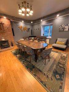 a living room with a wooden table and chairs at Opushka in Vorobʼyëvka