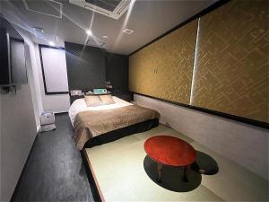 a bedroom with a bed and a table in it at Hotel U in Tokyo