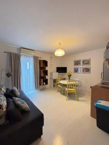 a living room with a couch and a dining room at LEGRAND Town Center in Makarska