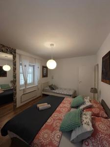 a bedroom with a large bed with pillows on it at LEGRAND Town Center in Makarska