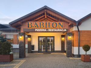 a building with a sign for a pizza restaurant at Babilon Krzeszów in Krzeszów