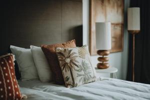 a bedroom with a bed with pillows at Van der Valk Hotel Gent-Drongen in Ghent