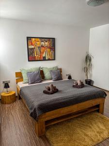 a bedroom with a large bed with two towels on it at Ubytování pod Borovou in Malenovice