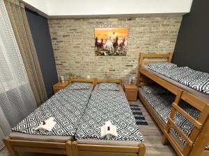 two bunk beds in a room with a brick wall at Vila Alexandra 2025 in Bačka Topola +61 photos