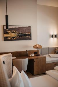a hotel room with a bed and a desk at Hotel Neubergerhof in Filzmoos +124 photos