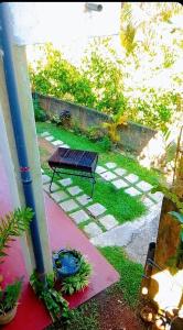 a bench sitting in the yard of a house at White Sky in Hikkaduwa