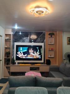 a living room with a tv and a couch at Welcome to Hambella home in Mactan