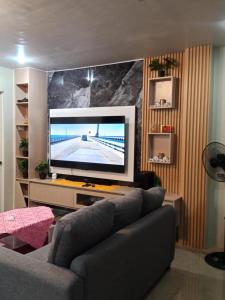a living room with a large flat screen tv at Welcome to Hambella home in Mactan