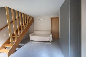 a room with a staircase with a bed in it at Borgo Agapito in Marciana